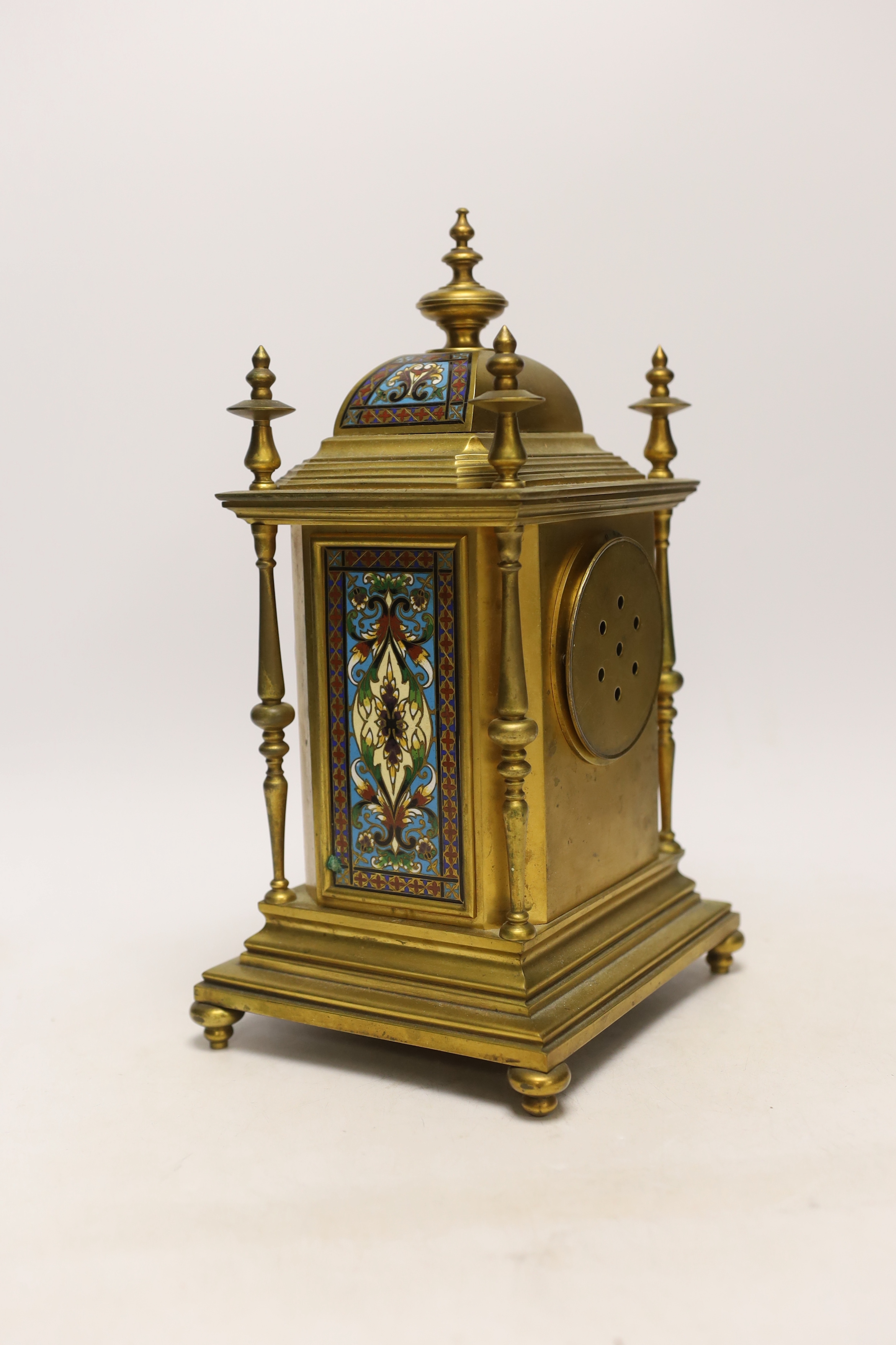 A late 19th/early 20th century French champleve and gilt metal clock garniture, 37cm